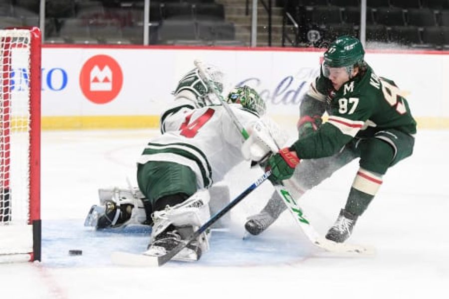 Forward Kirill Kaprizov (97) puts the breaks on and pokes the puck past goalie Kaapo Kahkonen (34) during the Minnesota Wild scrimmage at Xcel Energy Center in St. Paul on Friday, Jan 8, 2021. (John Autey / Pioneer Press)