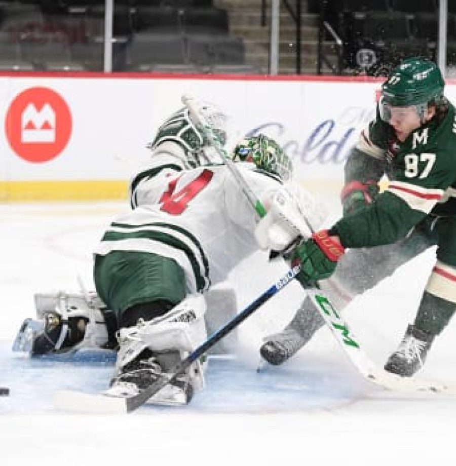 Forward Kirill Kaprizov (97) puts the breaks on and pokes the puck past goalie Kaapo Kahkonen (34) during the Minnesota Wild scrimmage at Xcel Energy Center in St. Paul on Friday, Jan 8, 2021. (John Autey / Pioneer Press)