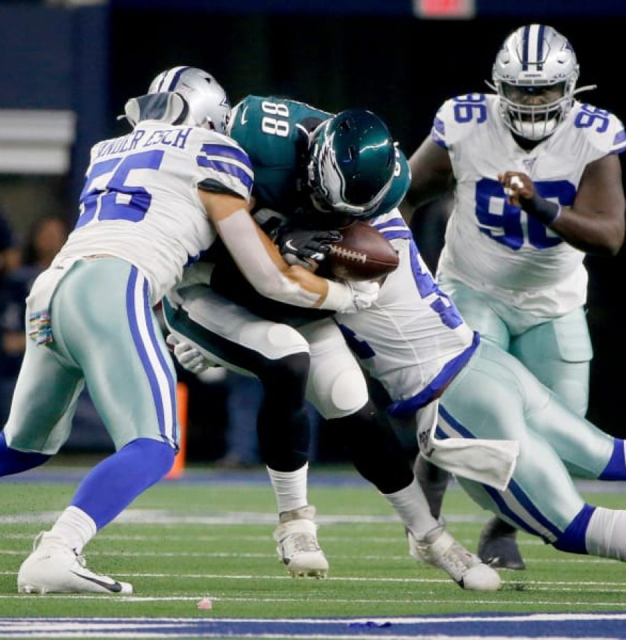 Dallas Cowboys' Leighton Vander Esch (55) and Jaylon Smith, right, tackle Philadelphia Eagles' Dallas Goedert (88) who fumbles the ball in the first half of an NFL football game in Arlington, Texas, Oct. 20, 2019. The Cowboys recovered the fumble. (AP Photo/Michael Ainsworth)