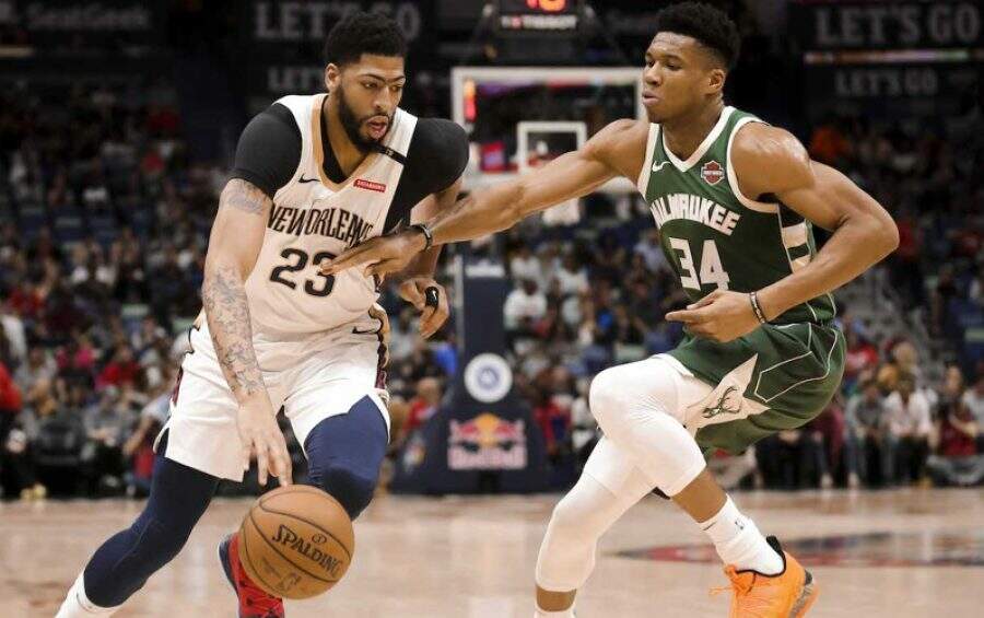 Mar 12, 2019; New Orleans, LA, USA; New Orleans Pelicans forward Anthony Davis (23) drives past Milwaukee Bucks forward Giannis Antetokounmpo (34) during the first quarter at the Smoothie King Center. Mandatory Credit: Derick E. Hingle-USA TODAY Sports - 12334062