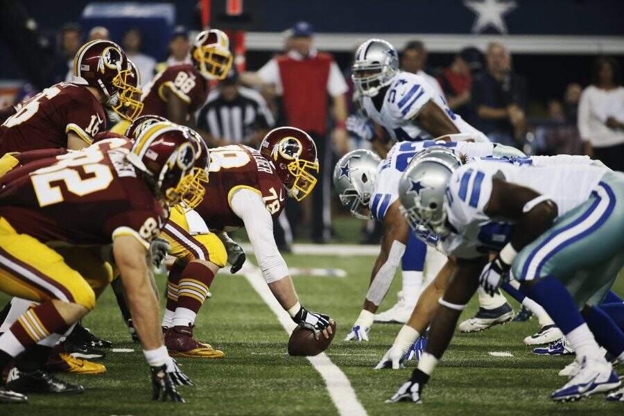 The Washington Redskins offense lines up against the Dallas Cowboys defense during the first half of an NFL football game, Monday, Oct. 27, 2014, in Arlington, Texas. Washington won 20-17 in overtime. (AP Photo/Brandon Wade)