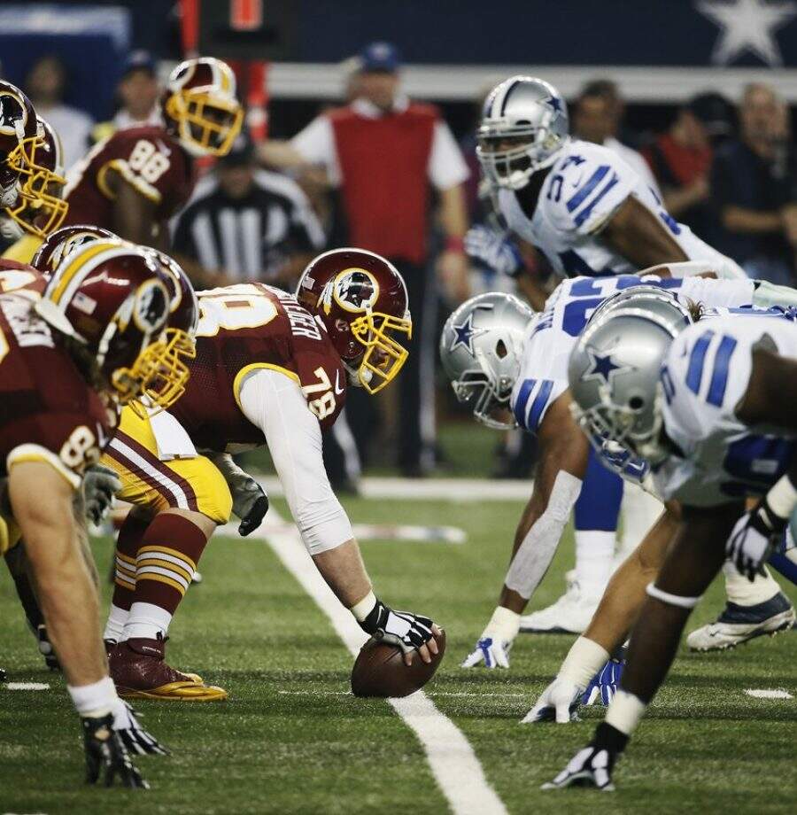 The Washington Redskins offense lines up against the Dallas Cowboys defense during the first half of an NFL football game, Monday, Oct. 27, 2014, in Arlington, Texas. Washington won 20-17 in overtime. (AP Photo/Brandon Wade)