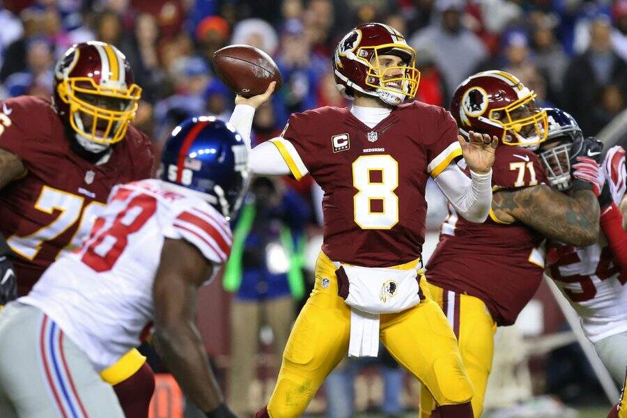 Jan 1, 2017; Landover, MD, USA; Washington Redskins quarterback Kirk Cousins (8) throws the ball as New York Giants defensive end Owa Odighizuwa (58) chases in the third quarter at FedEx Field. The Giants won 19-10. Mandatory Credit: Geoff Burke-USA TODAY Sports
