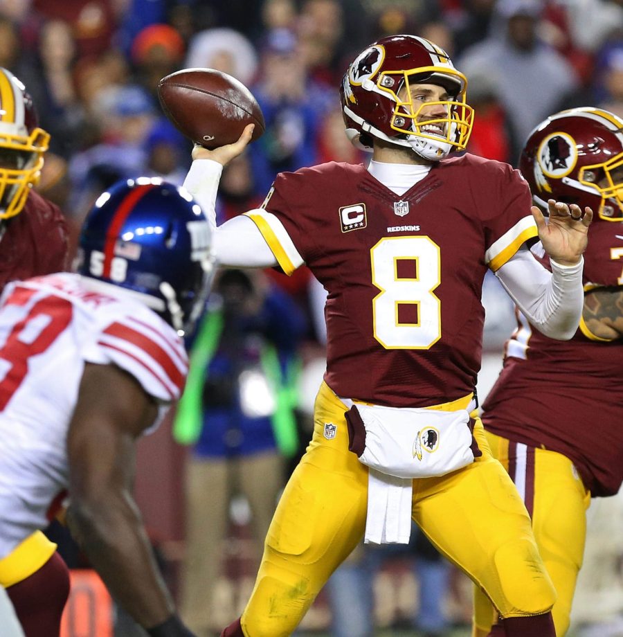 Jan 1, 2017; Landover, MD, USA; Washington Redskins quarterback Kirk Cousins (8) throws the ball as New York Giants defensive end Owa Odighizuwa (58) chases in the third quarter at FedEx Field. The Giants won 19-10. Mandatory Credit: Geoff Burke-USA TODAY Sports