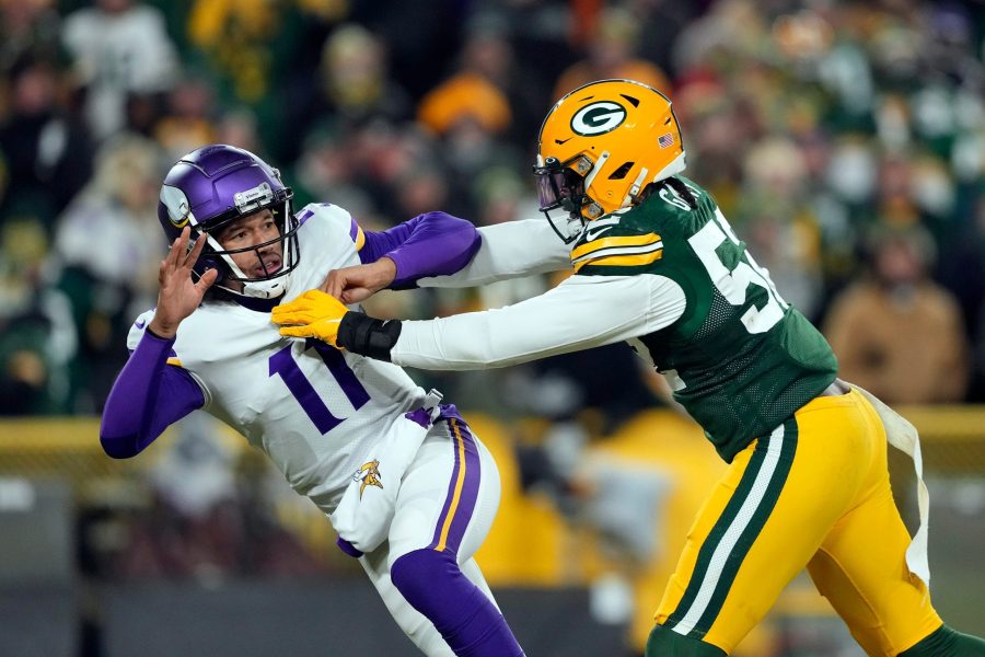 GREEN BAY, WISCONSIN - JANUARY 02:  Quarterback Kellen Mond #11 of the Minnesota Vikings is hit by outside linebacker Rashan Gary #52 of the Green Bay Packers applies pressure during the 4th quarter of the game at Lambeau Field on January 02, 2022 in Green Bay, Wisconsin. (Photo by Patrick McDermott/Getty Images)