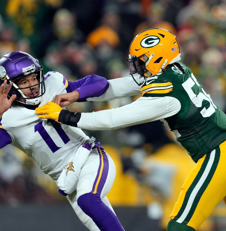 GREEN BAY, WISCONSIN - JANUARY 02:  Quarterback Kellen Mond #11 of the Minnesota Vikings is hit by outside linebacker Rashan Gary #52 of the Green Bay Packers applies pressure during the 4th quarter of the game at Lambeau Field on January 02, 2022 in Green Bay, Wisconsin. (Photo by Patrick McDermott/Getty Images)